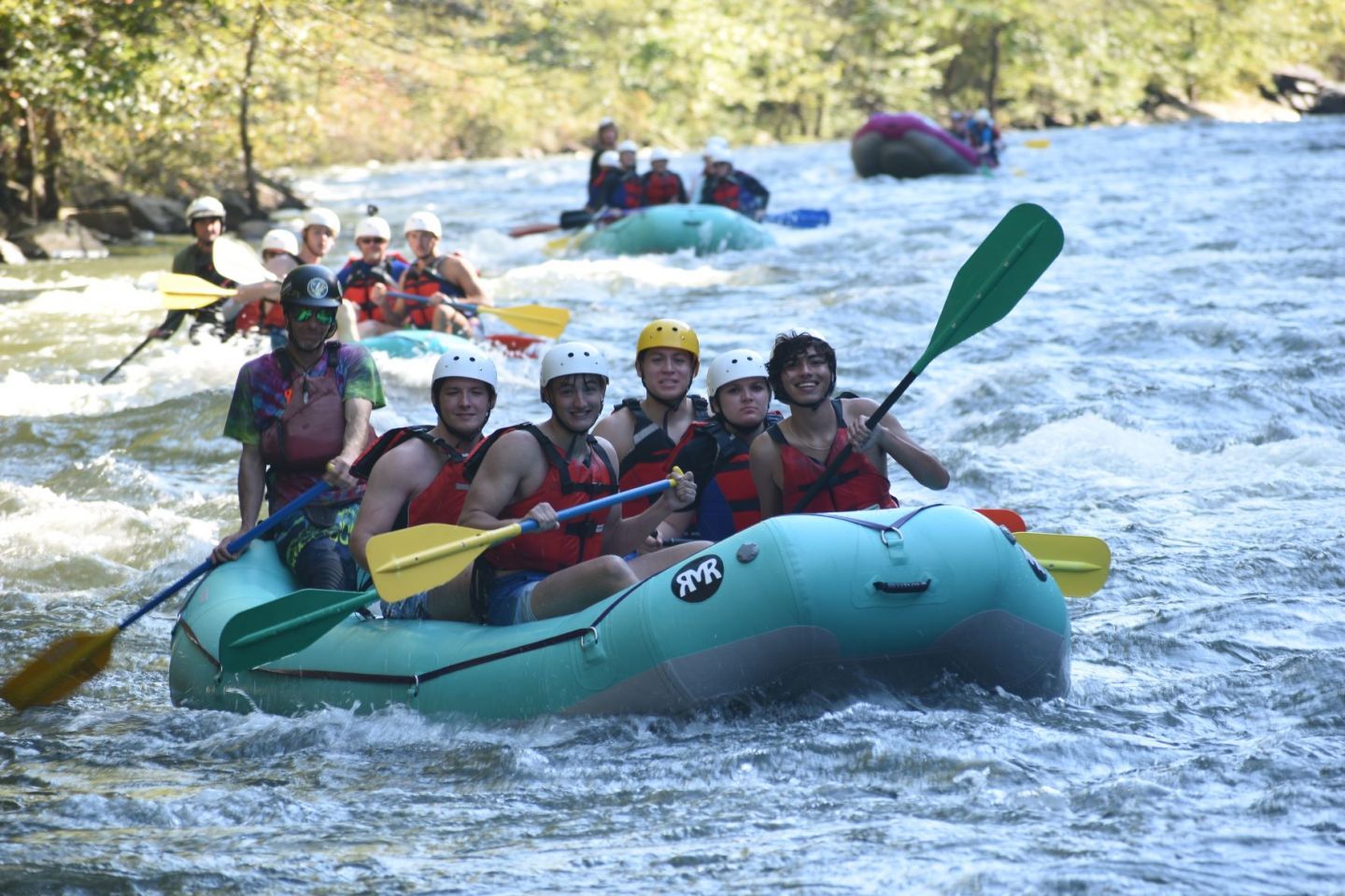 Honors College mentors rafting rapids on a river