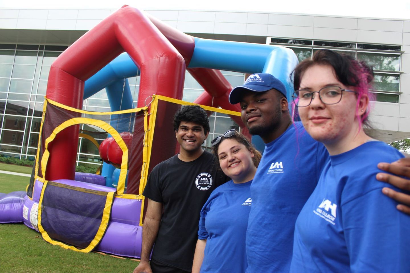 Honors College mentors posing in front of an inflatable bounce house