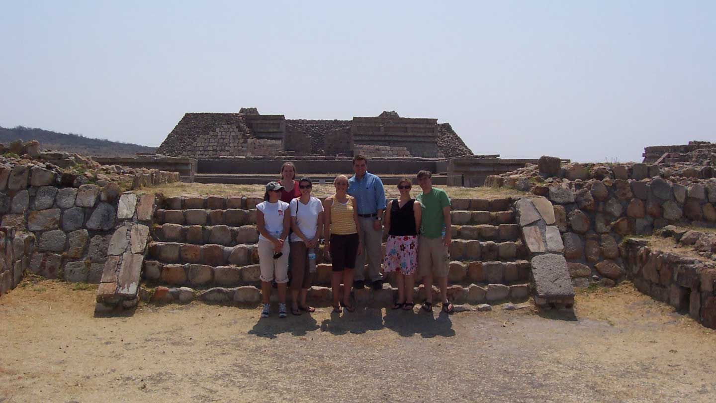 Students standing in front of ancient ruins in Mexico